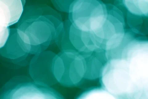 Dreamy teal bokeh lights pattern background for festive concepts Stock Photos