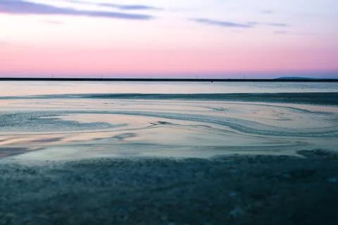 Dreamy Waterscape with Algae Patterns and Soft Pink Blue Sky Stock Photos