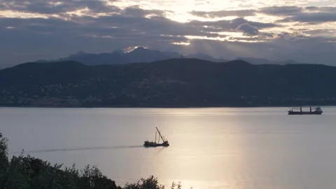 Dredge passes by the beautiful bay of La Spezia during sunrise Stock Footage 252244464