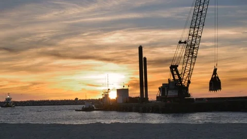 Dredger ship working at sunset with birds flying in background Stock Footage 74434048