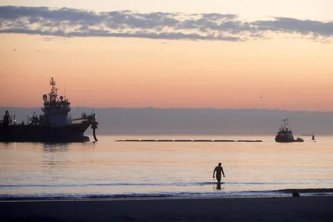 A dredger supplying sand to a beach Stock Photos