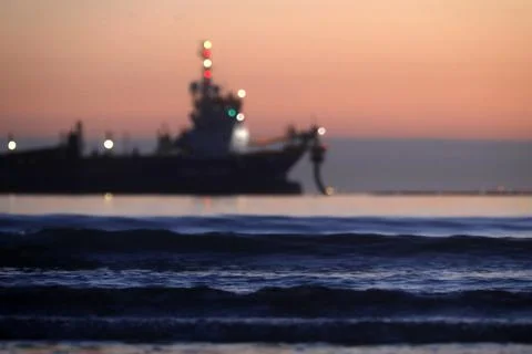 A dredger supplying sand to a beach Stock Photos