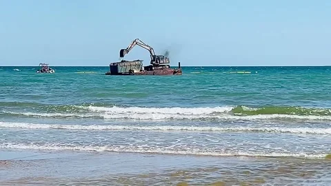 Dredging barge with excavator working in sea near coastline Stock Footage 305564675