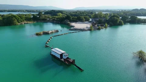 Dredging boat extracting sand and gravel from lake bed Stock Footage 338052240