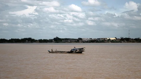 Dredging boat on river pumping riverbed sand under cloudy skies Stock Footage 102691829