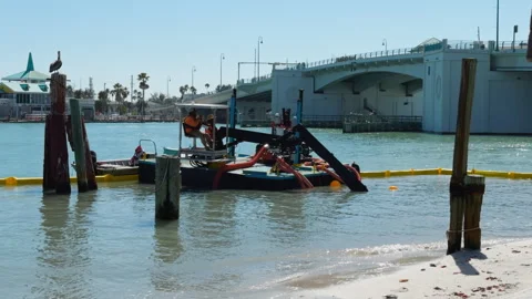 Dredging Equipment Operating on Shoreline Next to Bridge in Tampa Bay Stock Footage 334250156