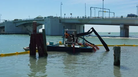 Dredging Machine Operating on Shoreline Next to Bridge in Tampa Bay 스톡 동영상 334250209