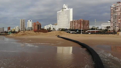 Dredging pipe and graders digging sand on beach. Video stock 145841040
