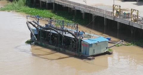 Dredging pumping equipment is used to pump the fluidized sand off the barge. Stock Footage 252377769