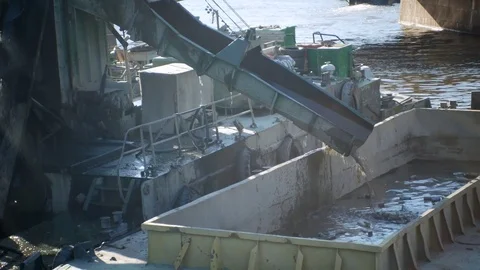 Dredging River : Crane scoops sand and mud from river bottom Stockbeeldmateriaal 78904271
