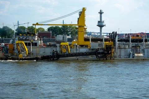 Dredging vessel in action on the river Stock Photos
