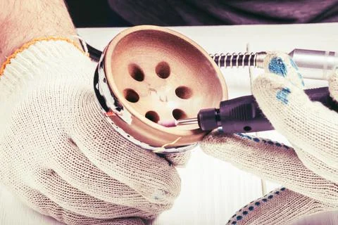 Dremel. precise and accurate processing of the product. on a wooden backgroun Stock Photos