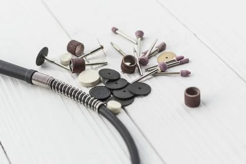 Dremel. precise and accurate processing of the product. on a wooden backgroun Stock Photos