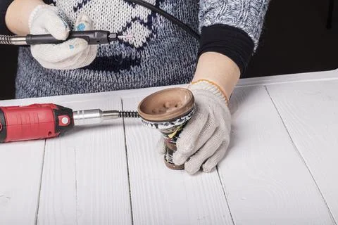 Dremel. precise and accurate processing of the product. on a wooden backgroun Stock Photos