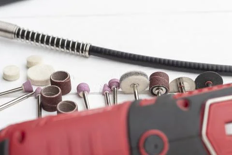 Dremel. precise and accurate processing of the product. on a wooden backgroun Stock Photos