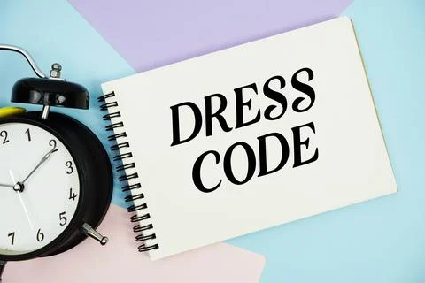Dress Code text written on notepad with alarm clock flat lay on multicolor .. 스톡 사진