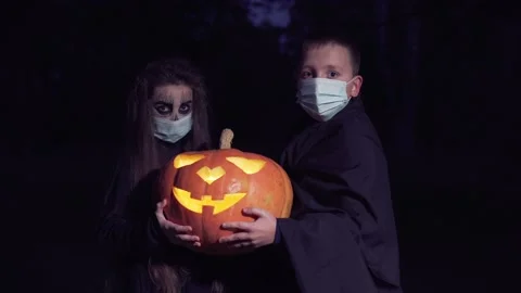 Dressed up children holding pumpkin lantern. Video stock 160371069