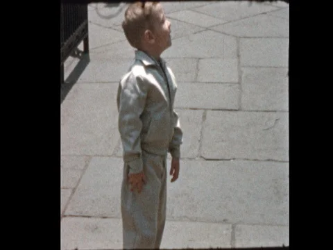 Dressed up Cute 50s boy points something out at the Zoo Stock-Footage 71395837