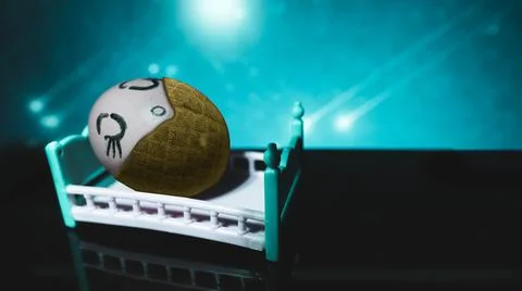 Dressed egg sleeps in bed, in the background of the star. Painted egg. Select Stock Photos