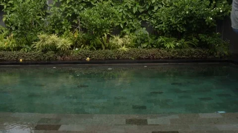 Dressed man fall in the swimming pool. Stock Footage 104348499
