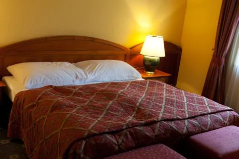 Dressed with a red coverlet bed Stock Photos