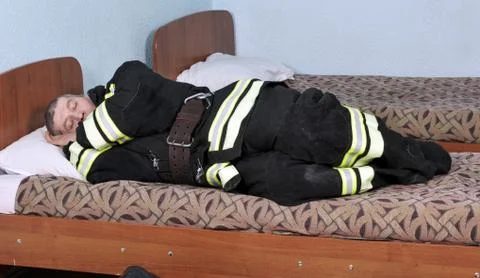 Dressed sleeping fireman Stock Photos