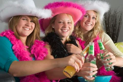 Dressed up teenage girls enjoying drinks Stock Photos