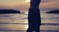 dressed woman in love runs to her man into the sea - hugs and kisses - sunset HD Footage