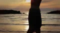 dressed woman in love runs to her man into the sea - hugs and kisses - sunset HD Footage