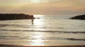 dressed woman in love runs to her man into the sea - hugs and kisses - sunset HD Footage