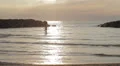 dressed woman in love runs to her man into the sea - hugs and kisses - sunset HD Footage