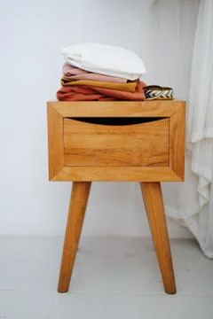 Dresses and bracelets on a bedside table. Frontal view. Stock Photos