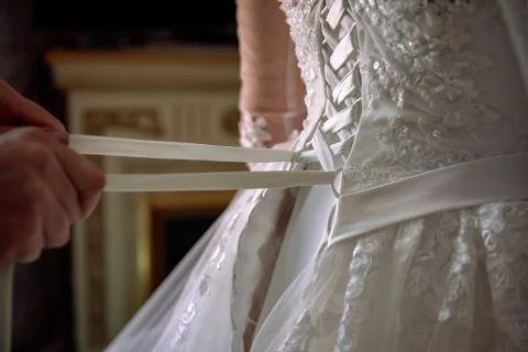 Dressing bride for wedding Stock Photos