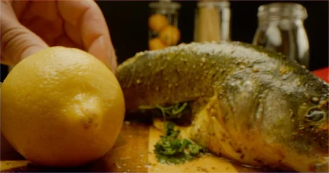 Dressing fish with lemon juice macro shot Video stock 126287686