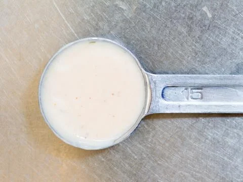 Dressing in the measuring spoon Stock Photos