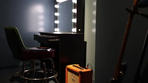 A dressing room setup for a performer, featuring a classic vanity mirror illumin Stock Footage 293564176