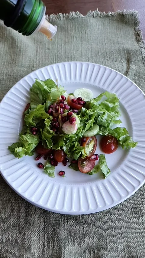 Dressing a salad with vinegar Stock Footage 300389224