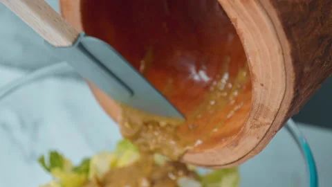 Dressing with sauce a freshly made Caesar Salad in 4K. Stock Footage 140768500
