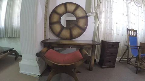 Dressing table with a curved chair,a commode and a blue rocking chair Stock-Footage 97227488