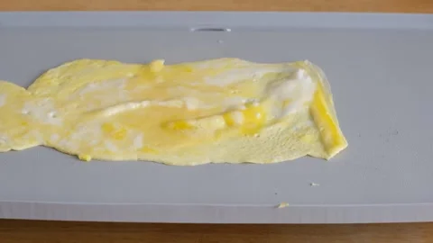 Dressing an ugly cheese and tomato omelet. Stock Footage 138339075