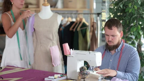 Dressmaker constructing custom dress on mannequin in sewing workshop Stock Footage 332638253