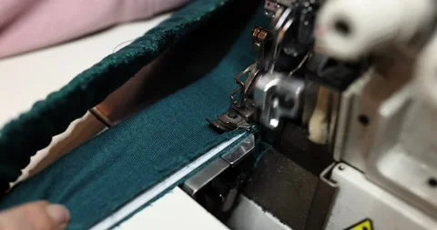 Dressmaker expertly stitches textile with overlock machine Video stock 277686379