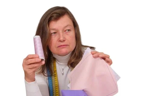 Dressmaker holding spool of thread and fabric on white background. Seamstress Stock Photos