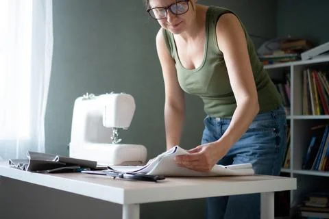 Dressmaker preparing fabric for cutting process Stock-Fotos