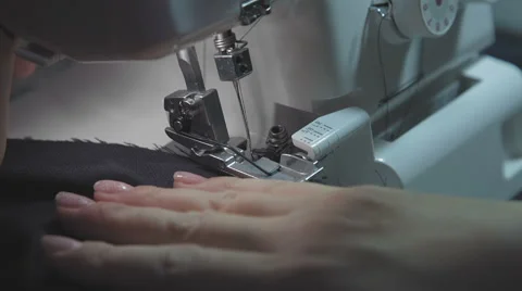 Dressmaker sewing overlock, close up Stock Footage 55797864