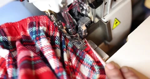 Dressmaker using overlock machine to secure fabric edges Video stock 269487076