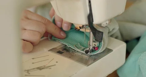 Dressmaker work on the sewing machine. Tailor making a garment in her workplace Stock Footage 200455273