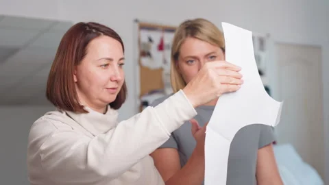 Dressmakers Discuss Cloth Pattern Design in Workshop Stock Footage 307136136