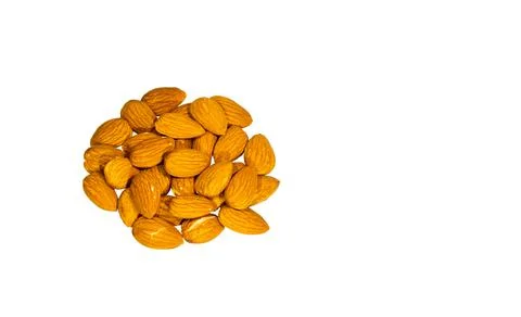 Dried almonds piled on a white backdrop. Stock Photos