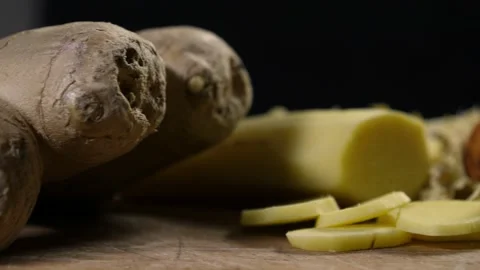 Dried and fresh ginger with a mortar and pestle on a wooden cutting board Video stock 204930991